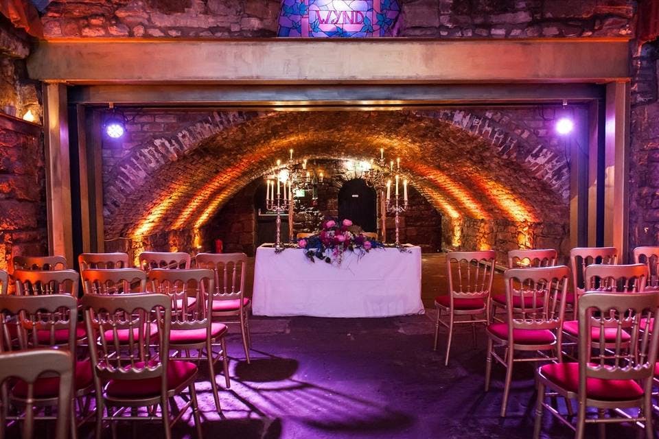 Vaulted Cellars event space with arched stone walls, ideal for weddings and gatherings.