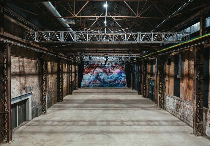 Spacious SWG3 warehouse venue with high ceilings for events and conferences.