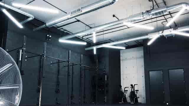 Modern industrial fitness space with exposed ductwork for health and wellness events.