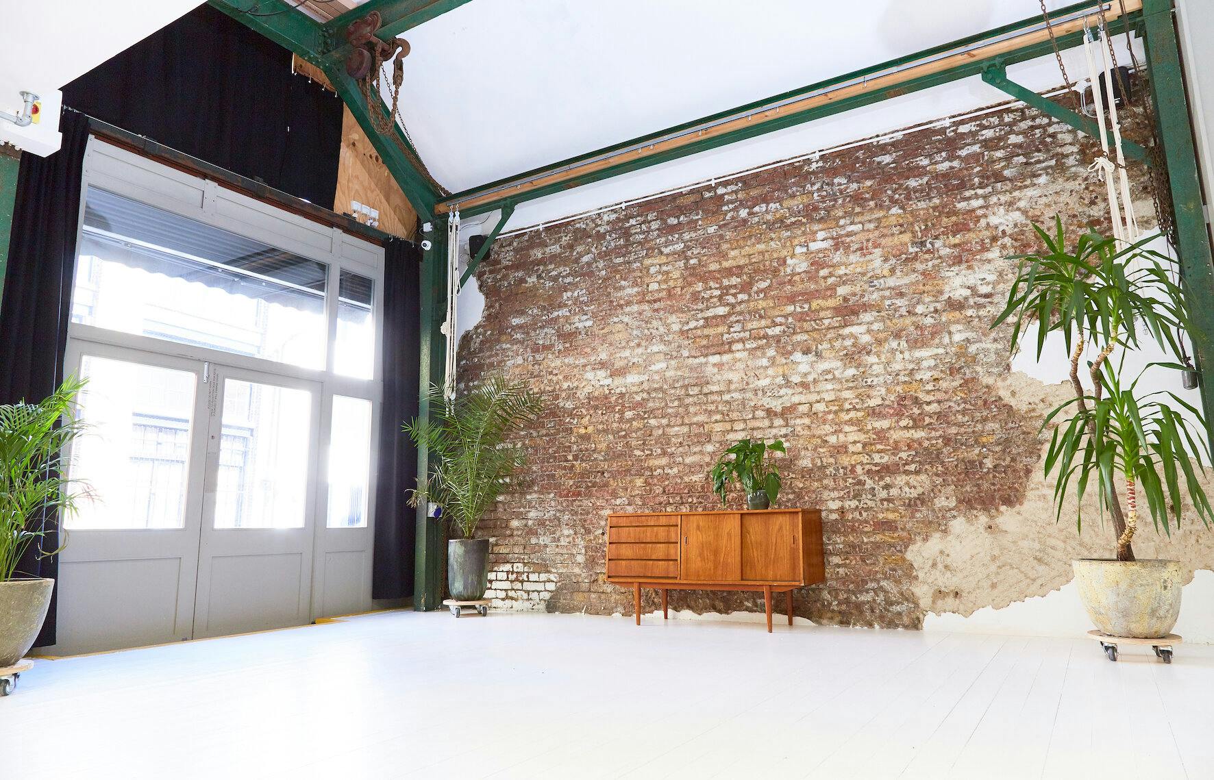 White Rabbit Cafe event space with exposed brick walls, ideal for gatherings and meetings.