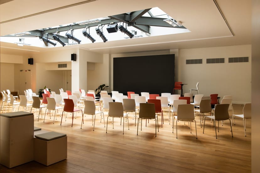 Versatile event space with chairs for presentations and workshops, featuring natural light.