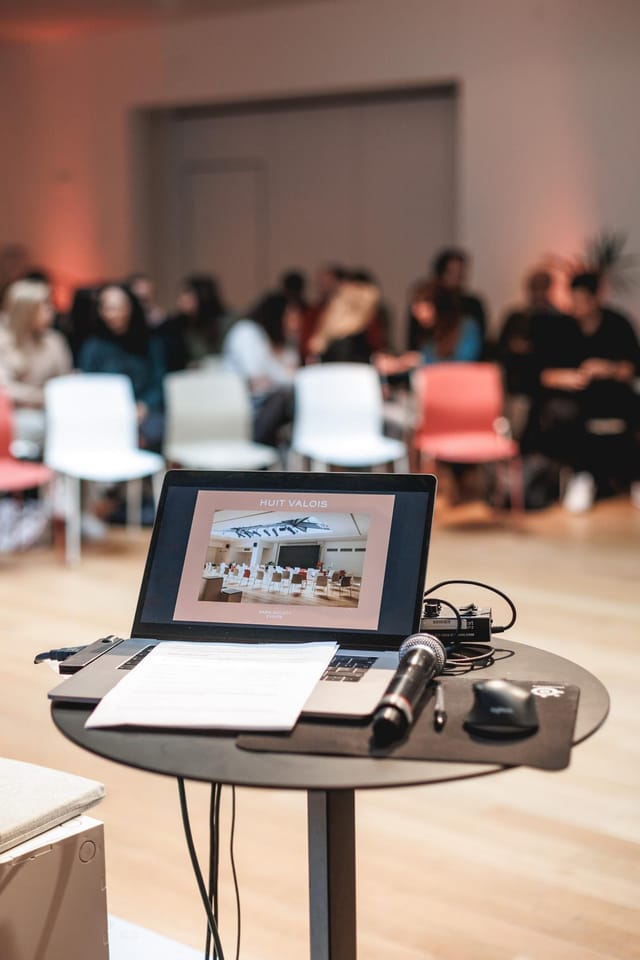 Plenary Area event setup with engaged audience and laptop for networking.