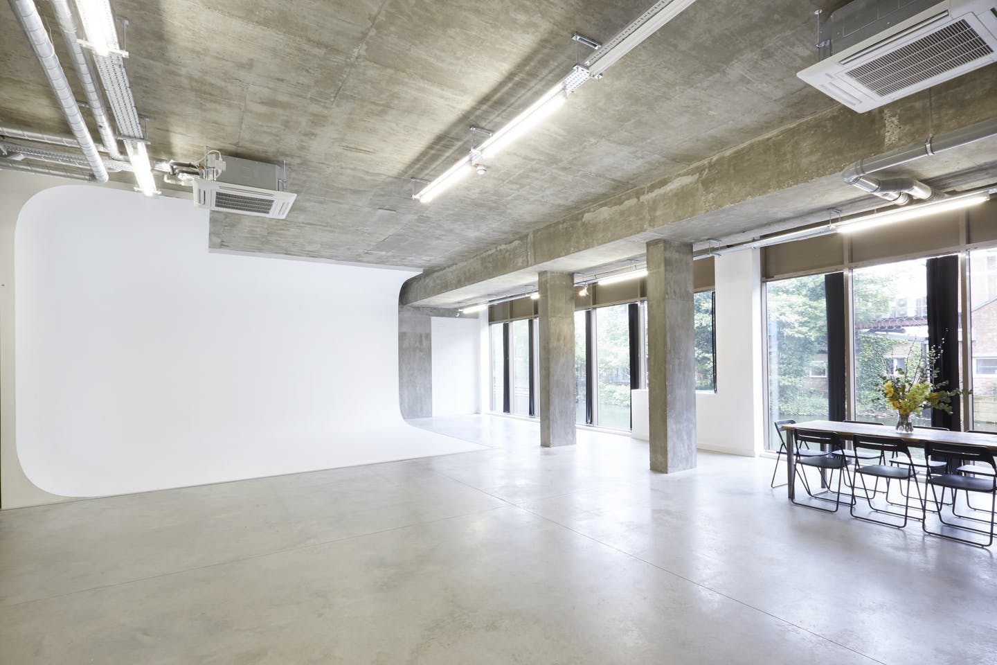 Modern industrial event space with natural light for corporate meetings and workshops.