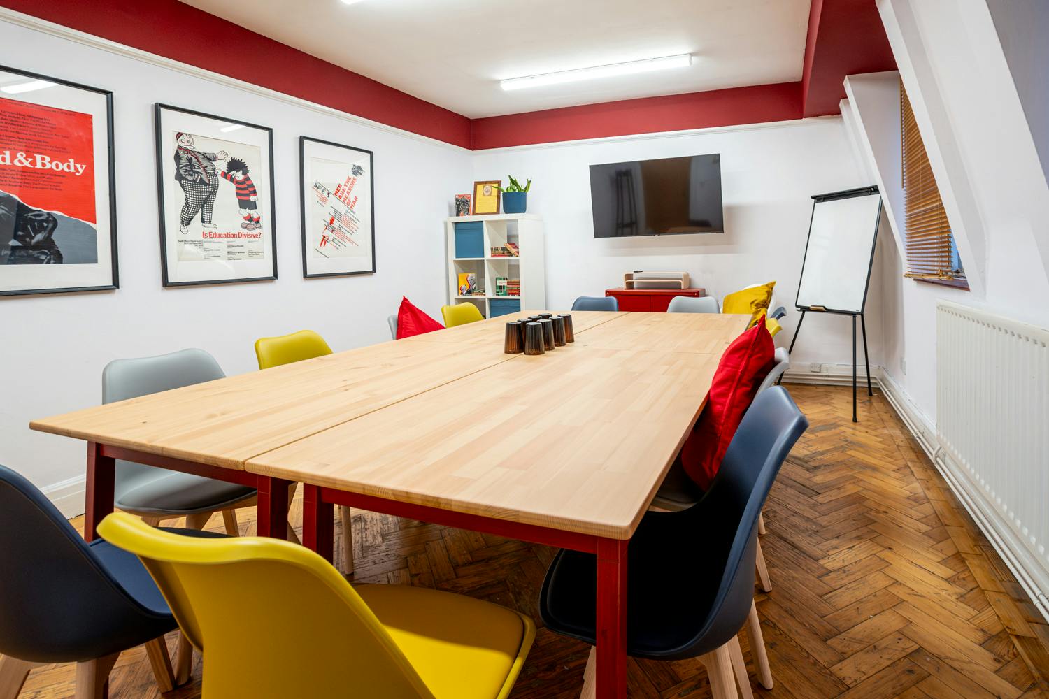 Flower Room in Conway Hall: vibrant meeting space with wooden table for events and presentations.