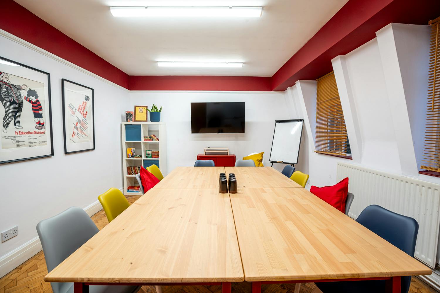 Conway Suite meeting room with wooden table, colorful chairs, ideal for events and presentations.