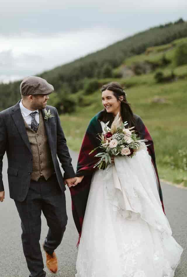 Couple eloping at Woodside Lodge, surrounded by lush greenery and romantic lighting.