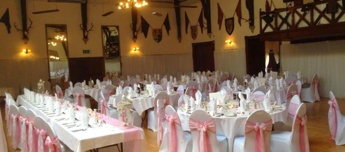 Elegant banquet hall with pink accents for weddings and formal events in Argyllshire.