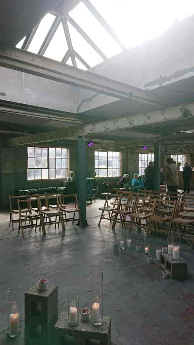 Versatile event space in The Biscuit Factory with natural light and cozy seating.
