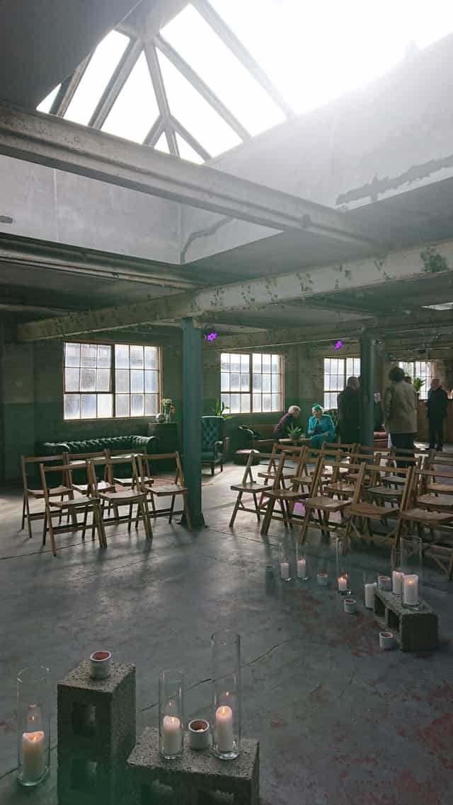 Versatile event space in The Biscuit Factory with natural light and cozy seating.