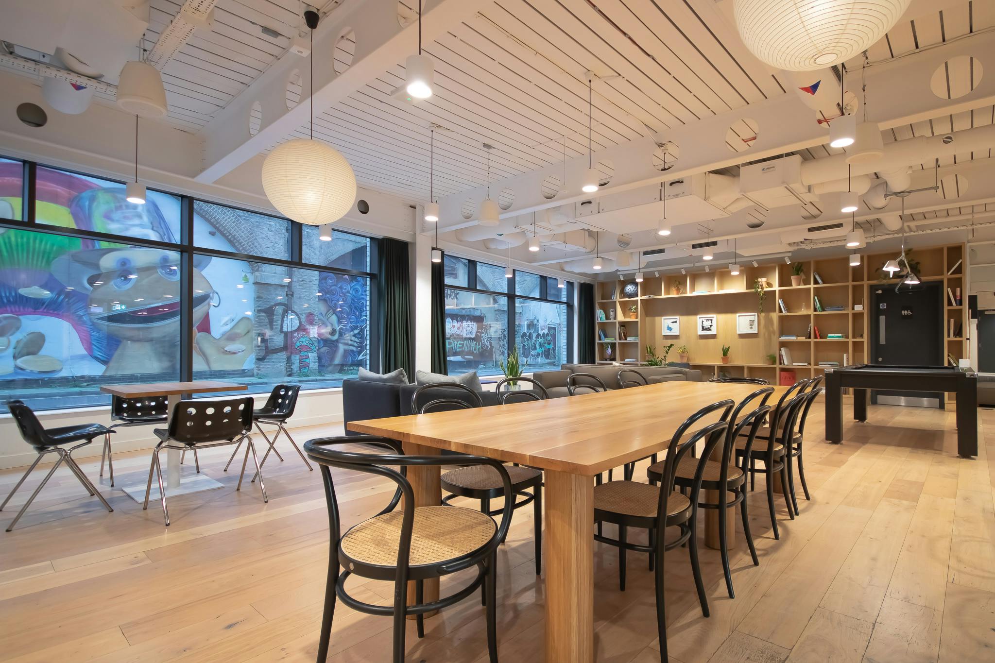 Versatile event space in Shoreditch with large wooden table for meetings and workshops.