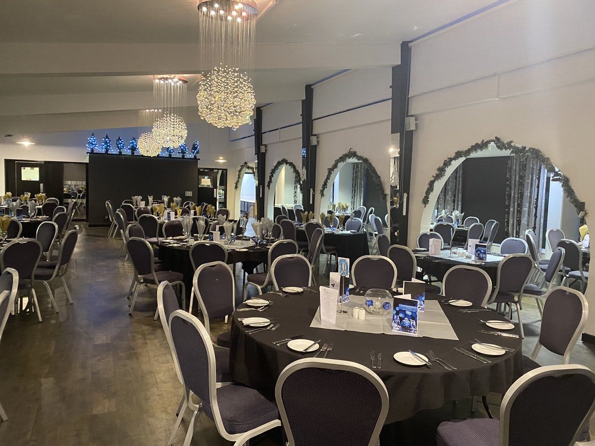 Main Meeting Room at Carnegie Conference Centre with elegant round tables for events.