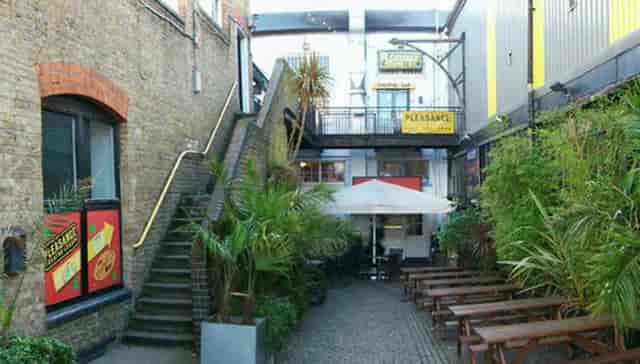Main House Cabaret London outdoor venue with lush greenery for networking events and meetings.