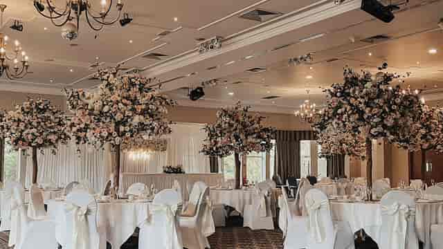 Elegant event space with floral centerpieces, perfect for weddings and upscale gatherings.