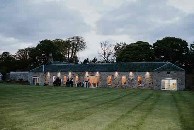 Kirknewton House Stables at twilight, ideal for weddings and outdoor events.
