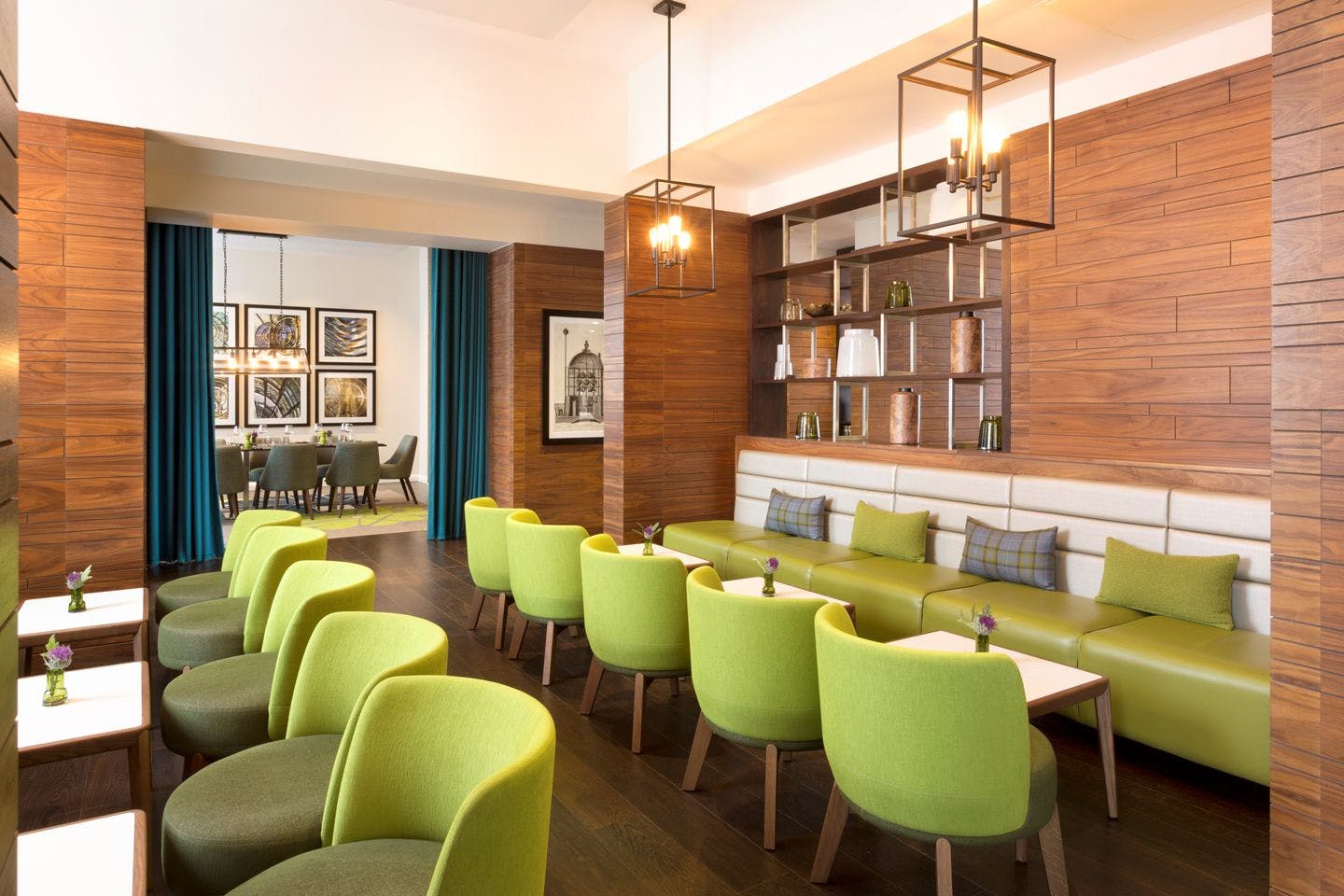 Modern meeting space with green seating, ideal for brainstorming and collaboration events.