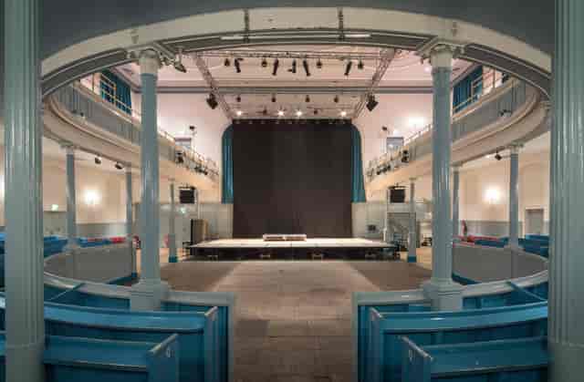 Ground Floor Seating at The Queen's Hall, spacious stage for conferences and performances.