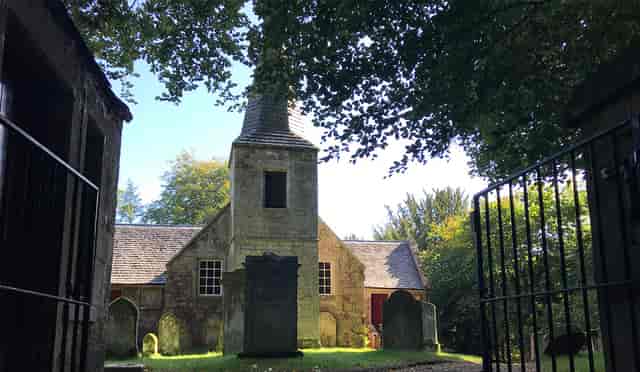 Old Kirk at Glencorse House, a rustic venue for weddings and events amidst greenery.