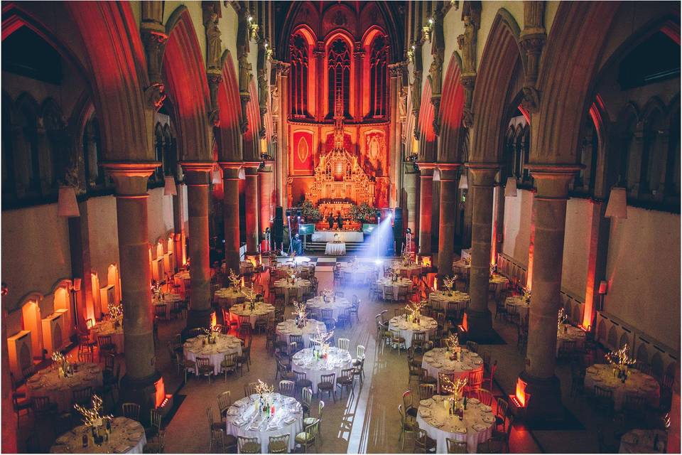 Corporate event space in Manchester Monastery with elegant round tables and soft lighting.