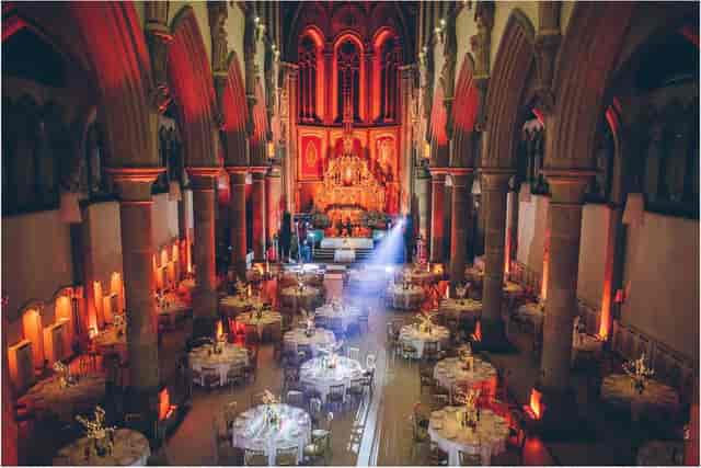 Corporate event space in Manchester Monastery with elegant round tables and soft lighting.