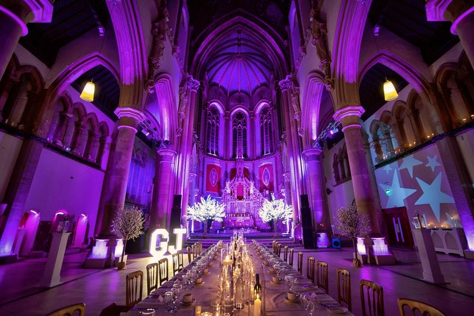 Elegant wedding venue in Manchester Monastery with dramatic lighting and intimate decor.