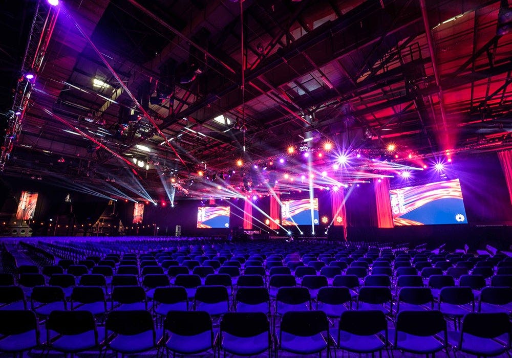 SEC Halls conference setup with black chairs and screens, ideal for presentations.