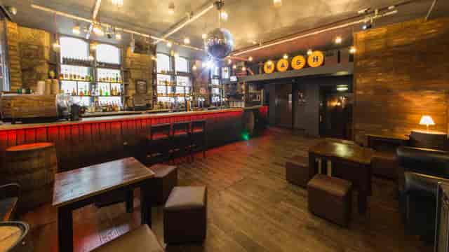 Loft-Inspired Bar at The Mash House, cozy wooden decor for networking events.