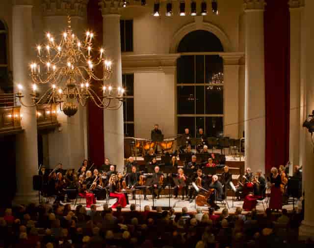 Orchestra performance at Sinfonia Smith Square, elegant venue with dramatic lighting.