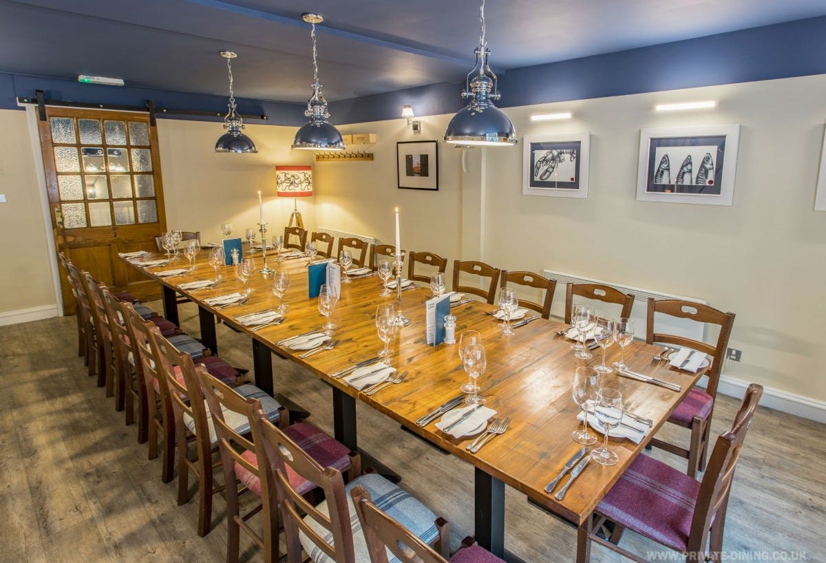 Private dining room with elegant table setting for corporate dinners and intimate gatherings.