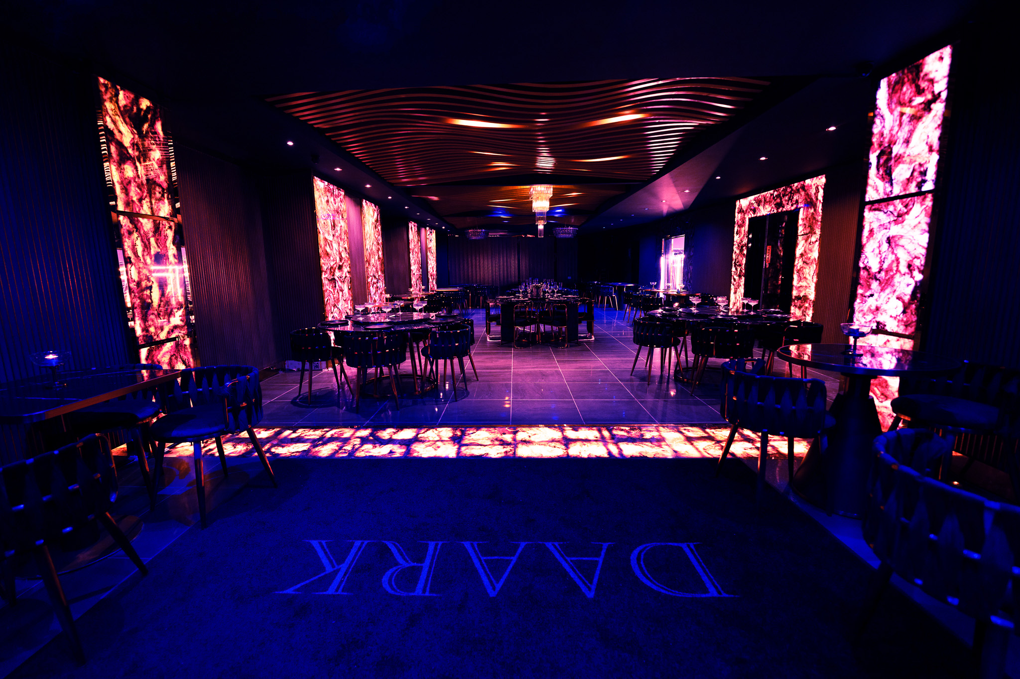 Modern event space at Daark Venue with vibrant lighting, perfect for gatherings and receptions. - Banner