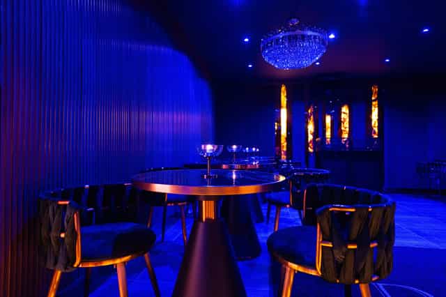 Elegant event space at Daark Venue with luxurious blue tones and ambient lighting.