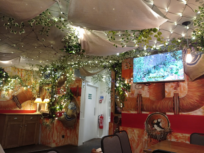 Event space at The Mercat Bar with greenery, lights for gatherings and presentations.