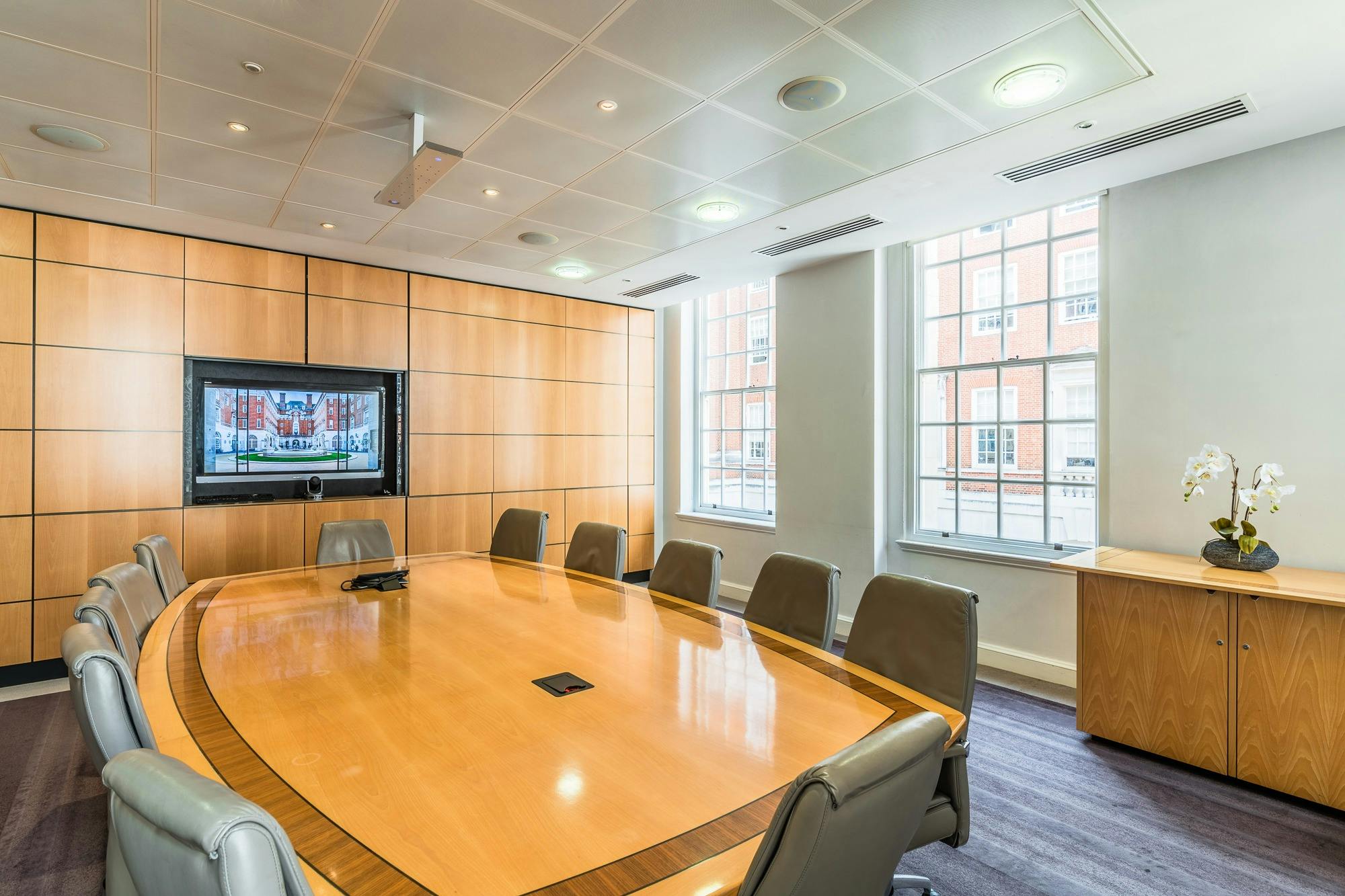 Modern conference room with oval table for meetings and presentations in BMA Scotland.