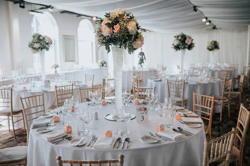 Elegant banquet hall with floral centerpieces for weddings and formal events.