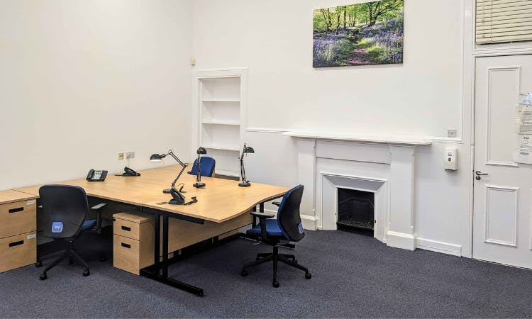 Minimalist interview room with large desk, ideal for meetings and brainstorming sessions.