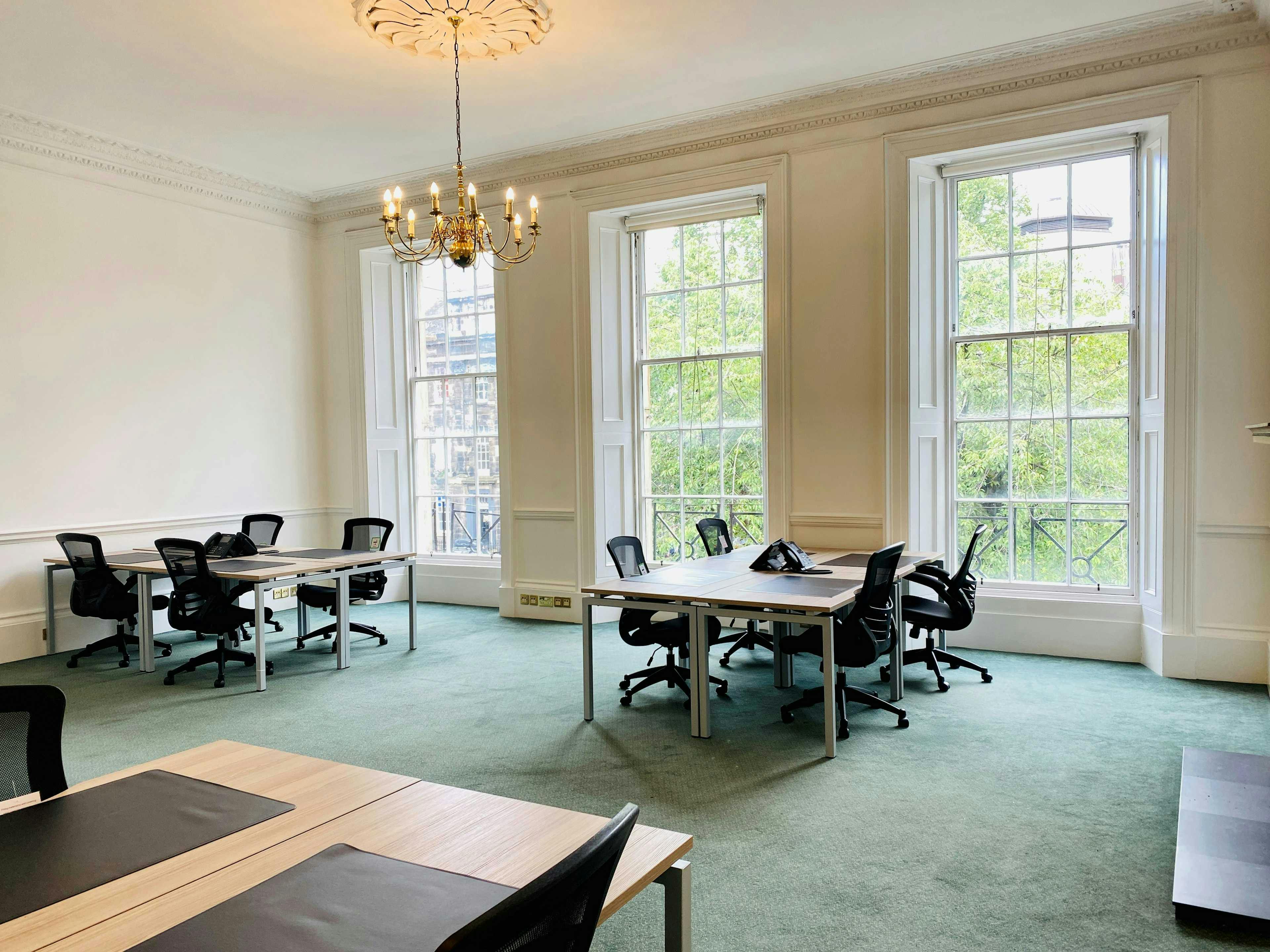 Bright meeting room with large windows, ideal for workshops and collaborative sessions.