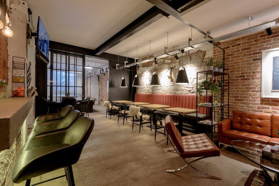 Modern event space with exposed brick walls, ideal for networking and meetings.