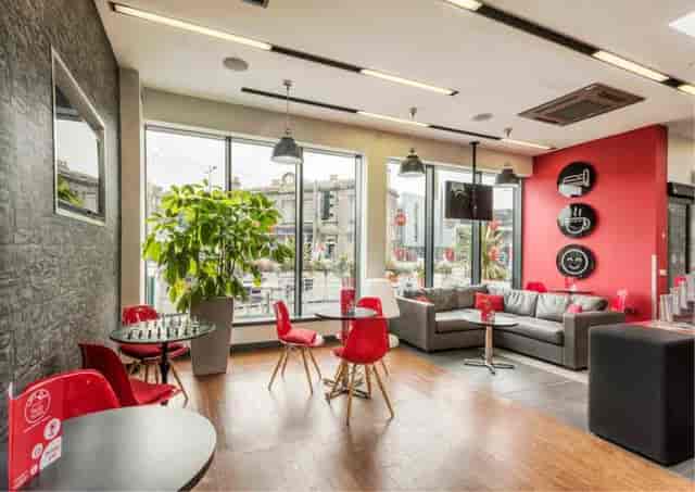 Modern meeting space with bright colors, ideal for team-building and networking events.