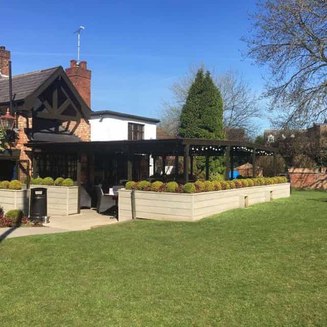 Charming Beer Garden venue with lush greenery, perfect for outdoor events and gatherings.