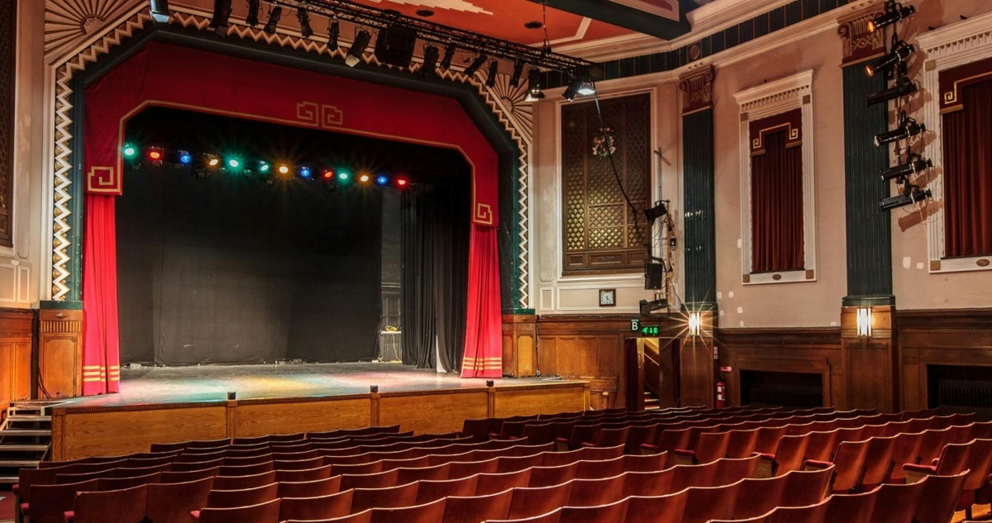 Main Auditorium at Carnegie Hall with vibrant stage and tiered seating for events.