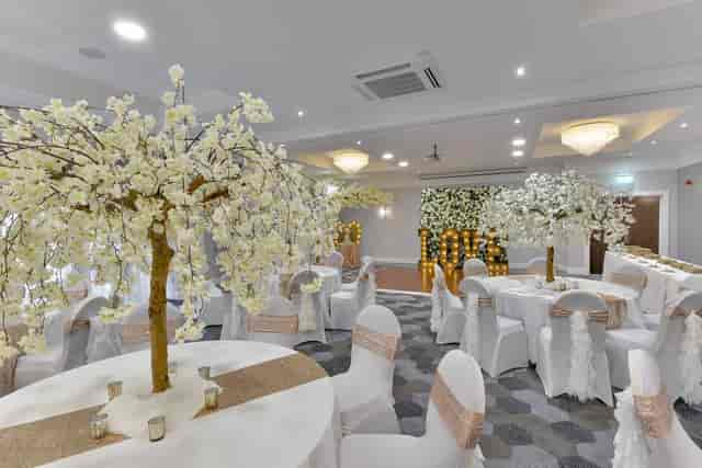 Elegant event space with cherry blossom trees, ideal for weddings and upscale gatherings.