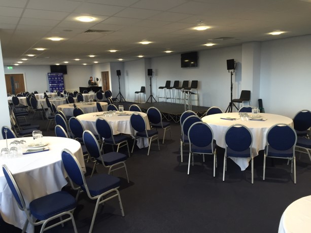 Versatile event space in Oldham with round tables, ideal for meetings and banquets. - Banner