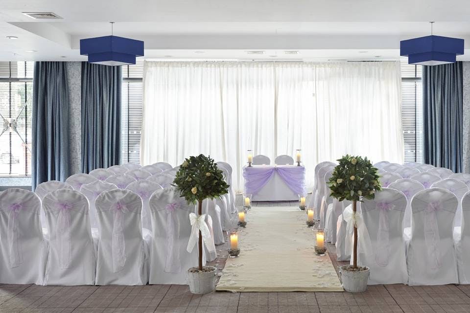 Elegant wedding event space with lavender accents and candlelit aisle at Village Hotel Edinburgh.