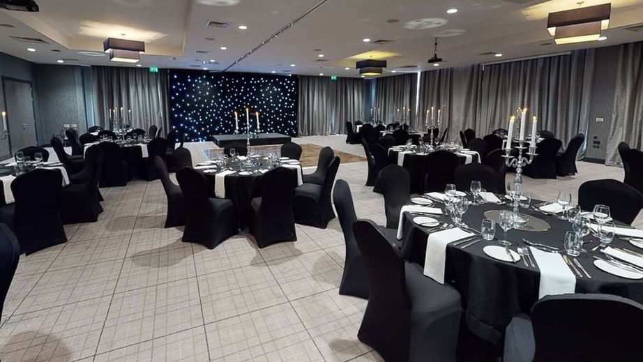 Elegant meeting room with candelabras, ideal for corporate events and celebrations. - Banner