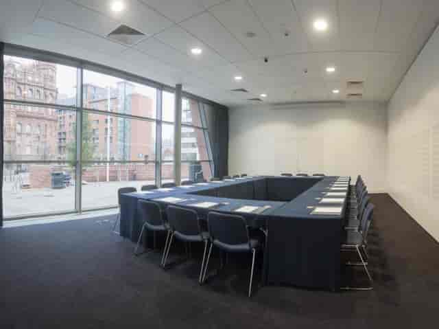 Manchester Central meeting room with large table, ideal for workshops and conferences.