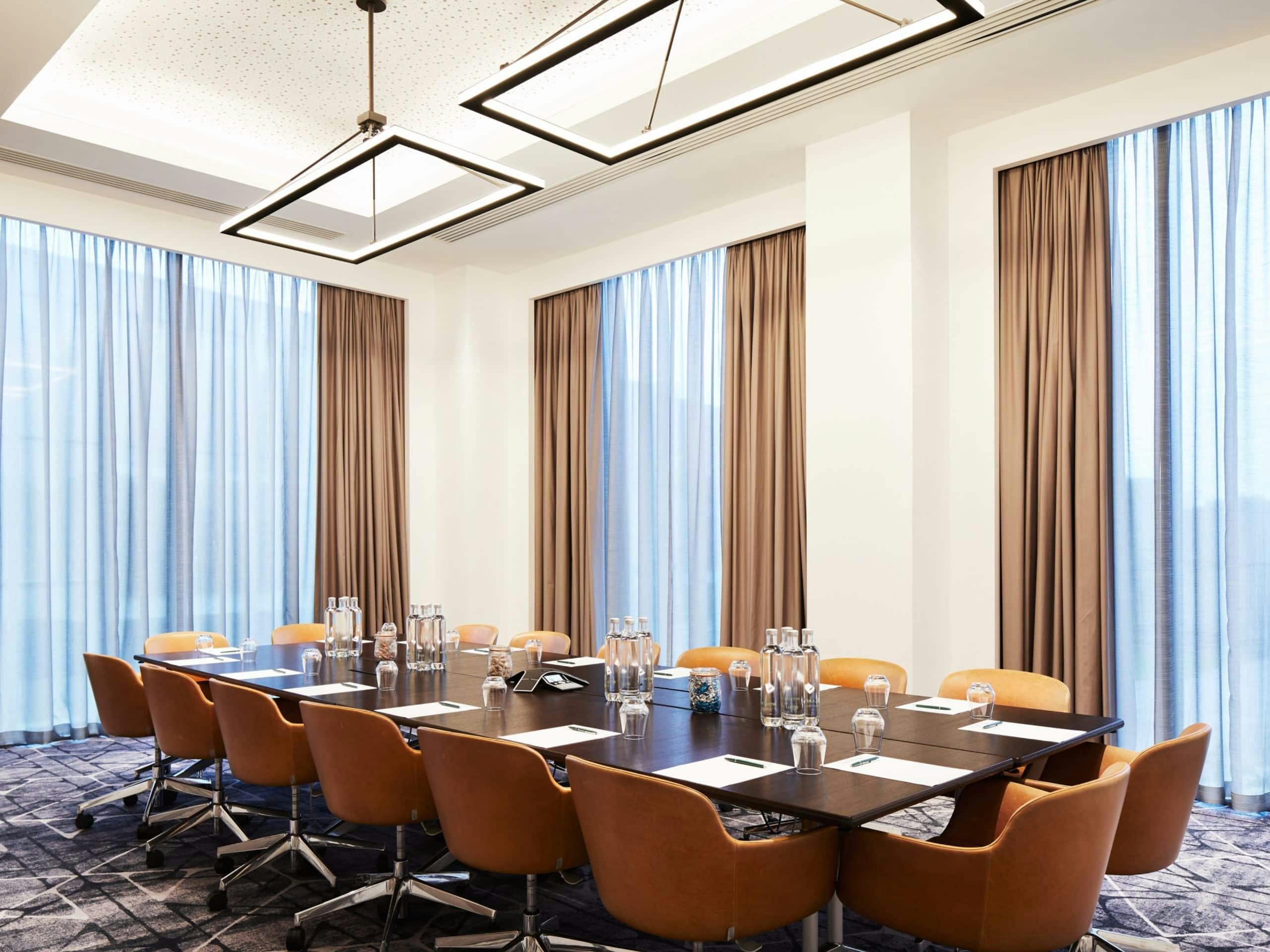 Modern meeting room with large table and ergonomic chairs at Manchester Conference Centre.