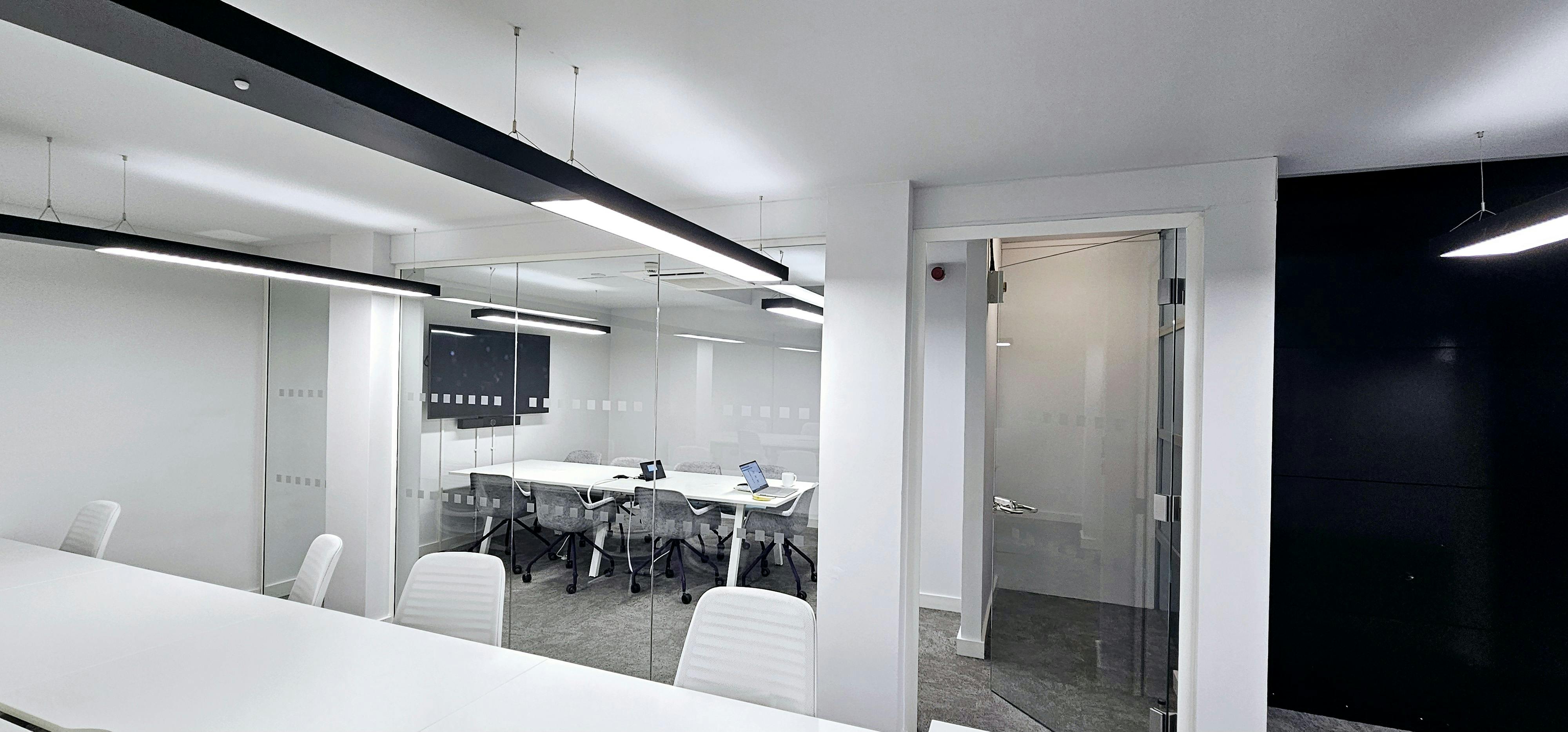 Modern meeting room with glass walls, ideal for collaborative business events.