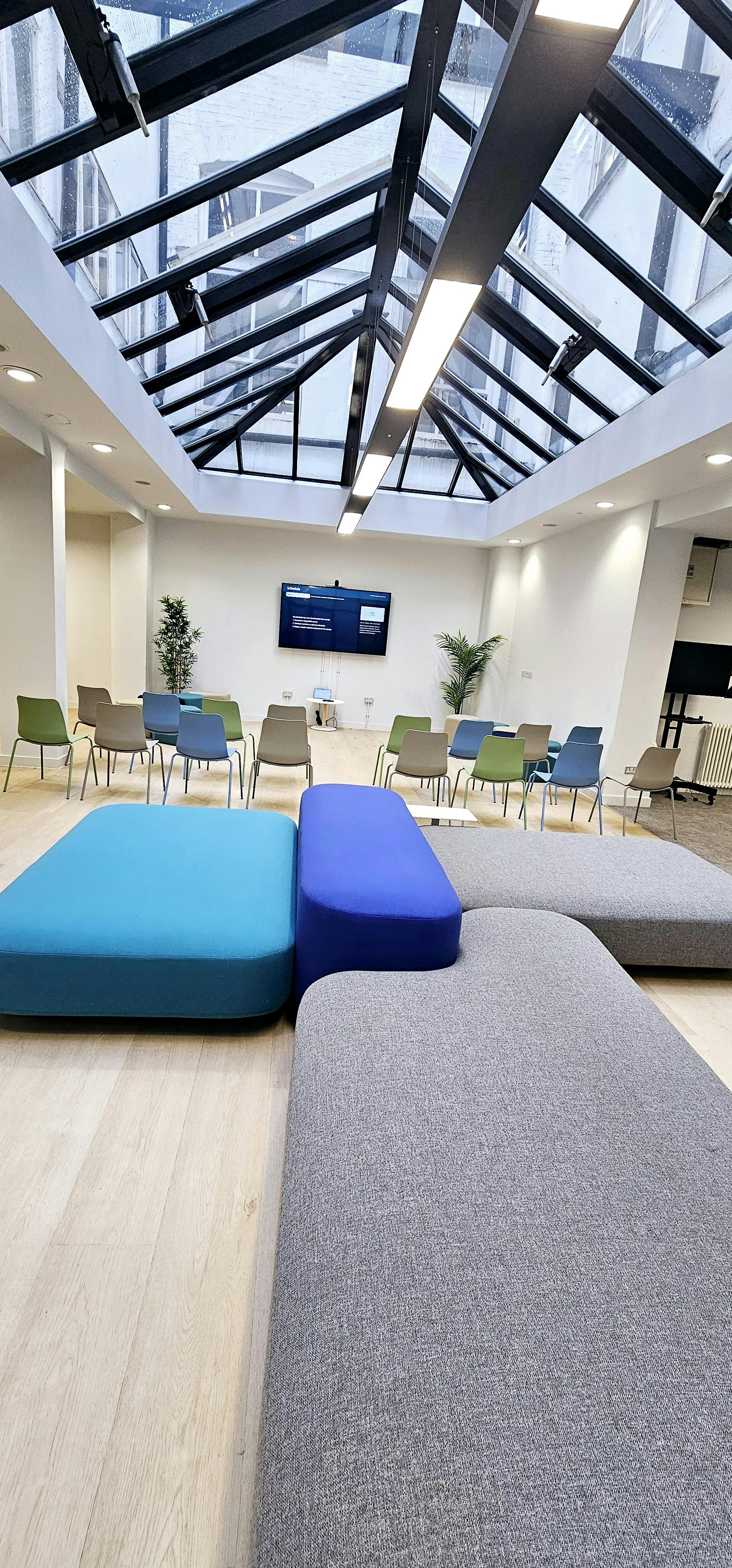 Versatile meeting space in ZEBOX UK with colorful seating for collaboration and networking.