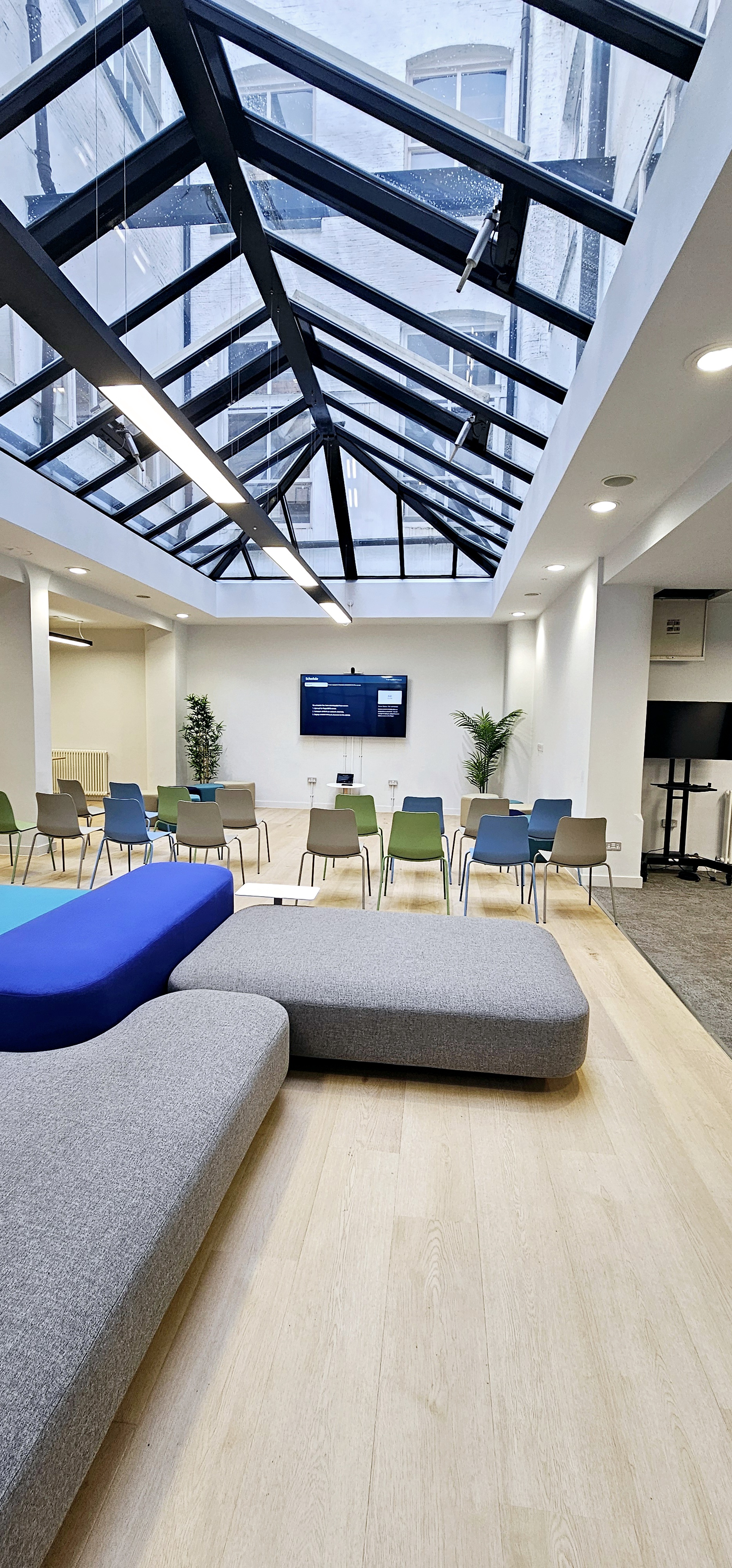 Versatile meeting space in ZEBOX UK with natural light, ideal for workshops and presentations. - Banner