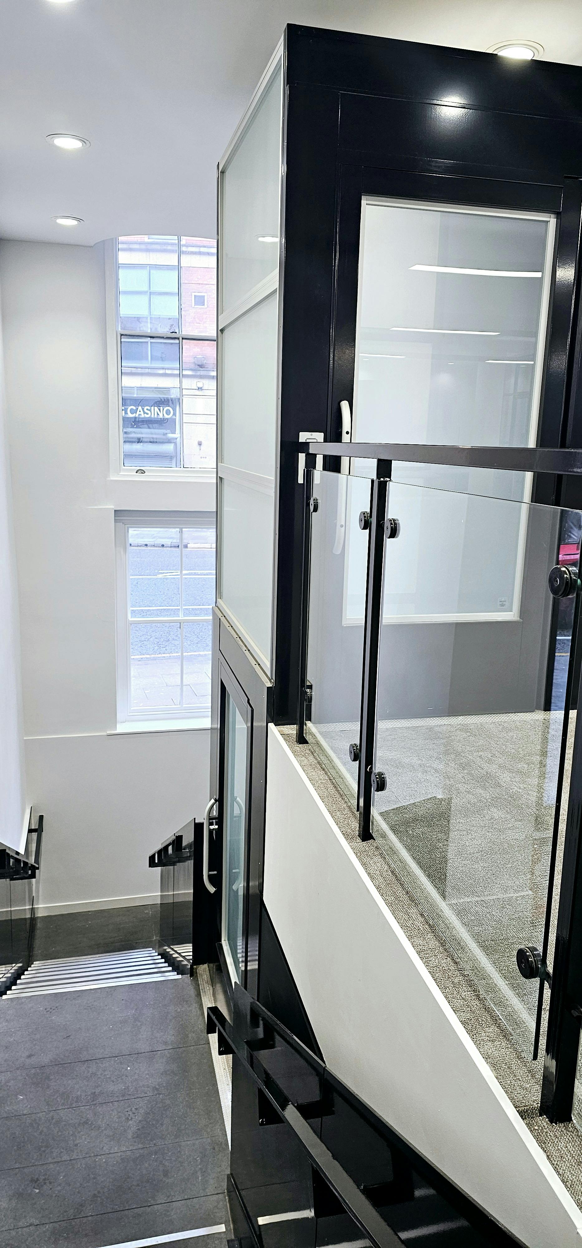 Modern flexible desk with glass railings, ideal for networking events and receptions.