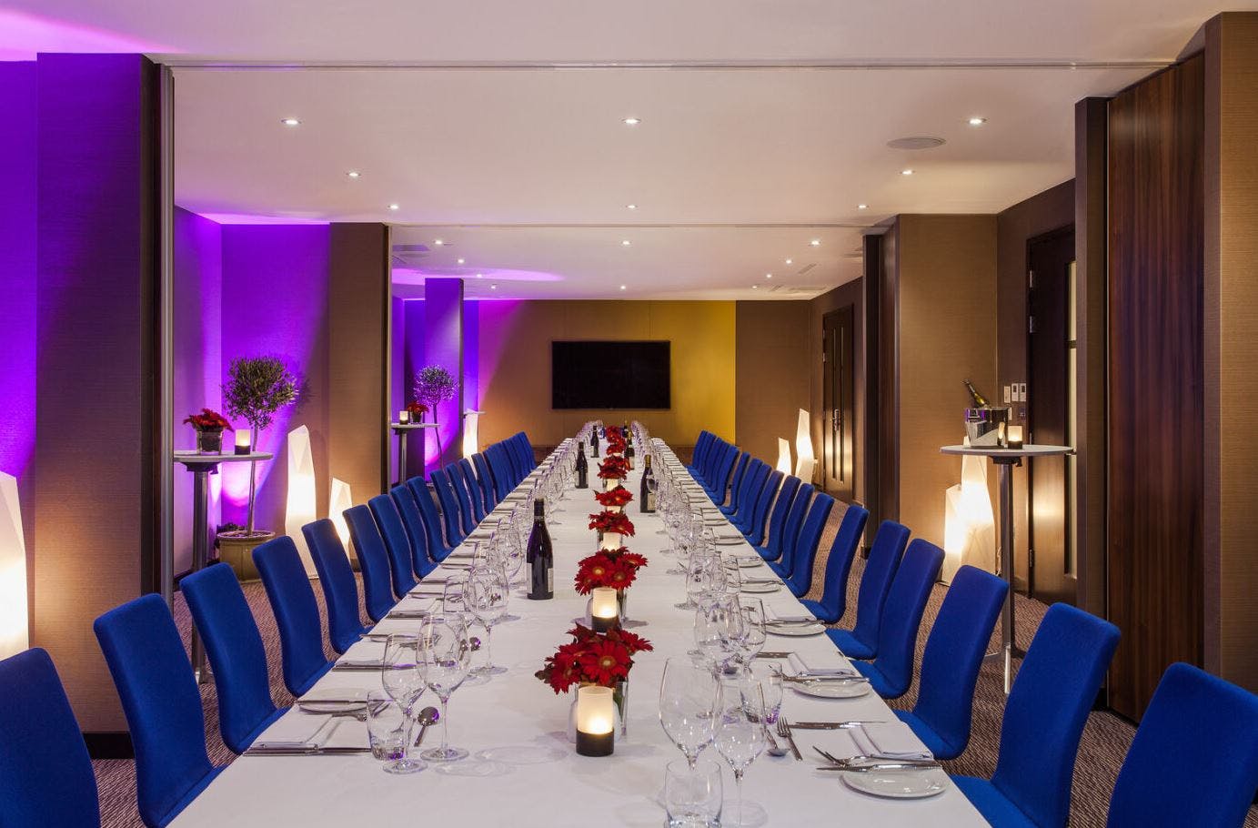 Elegant formal dinner setup with poinsettias in upscale Marlowe event space.